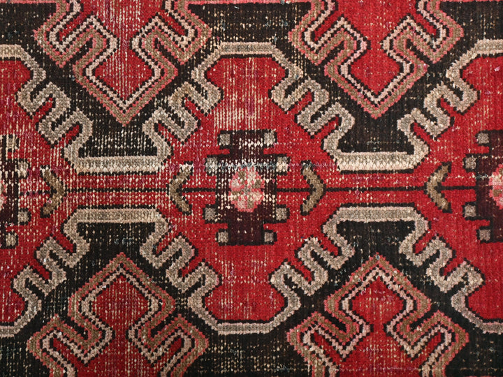 a close up of a red and black rug