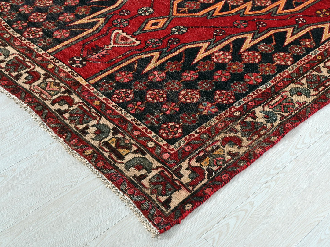a red oriental rug on a white floor