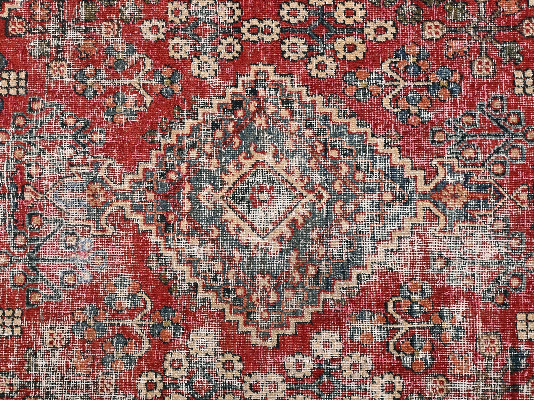 a red and blue rug with a pattern on it