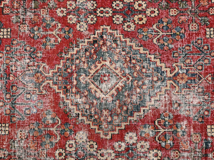 a red and blue rug with a pattern on it