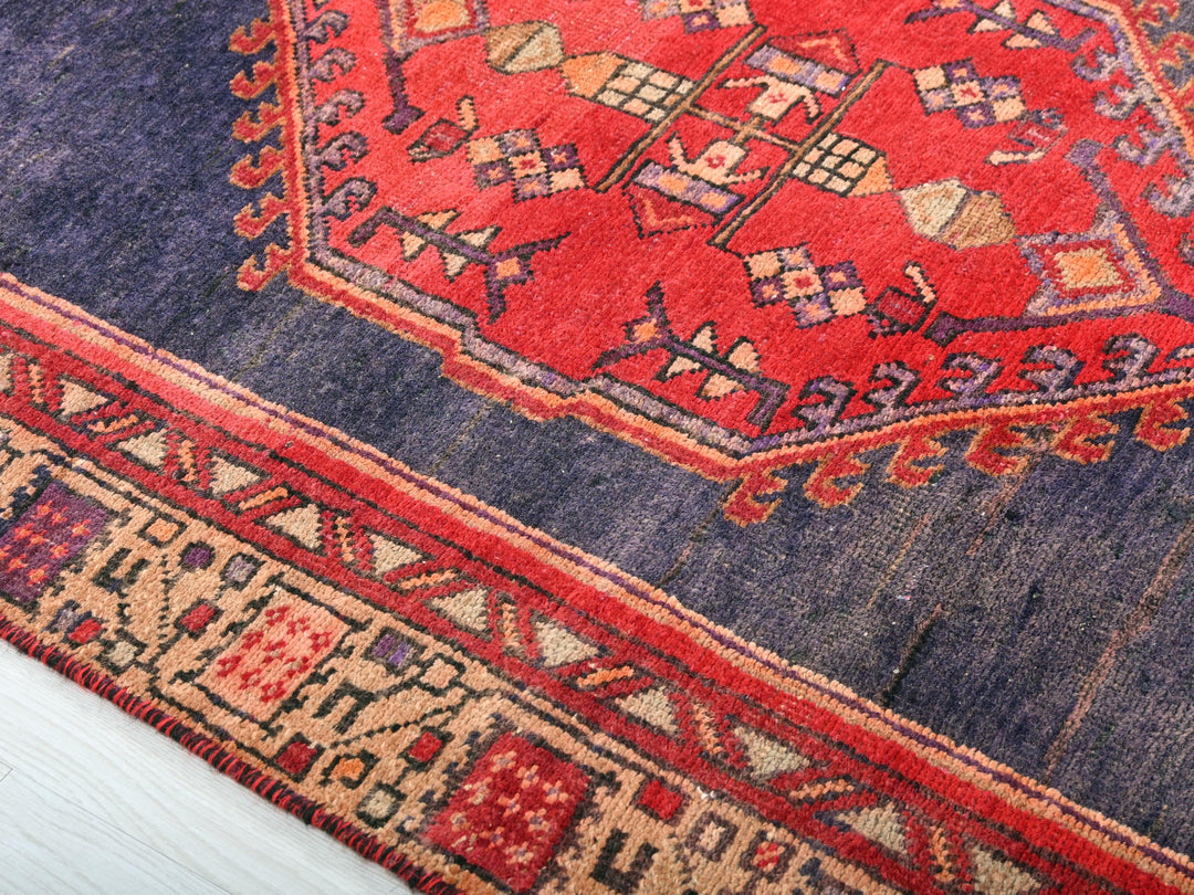 a blue and red rug with a red border