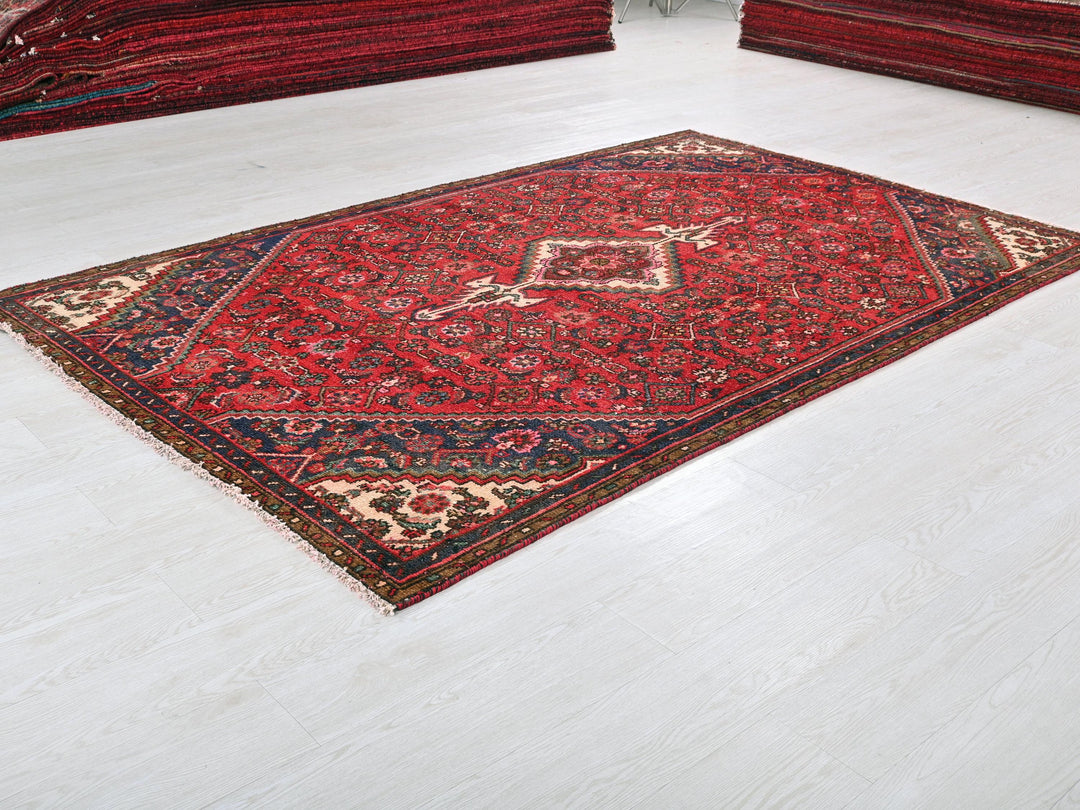 a red rug on the floor of a room