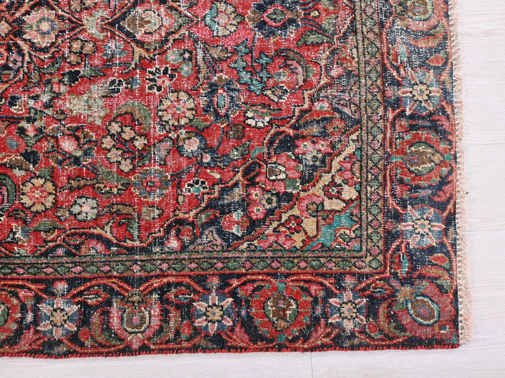 a red, blue, and green rug on a white surface