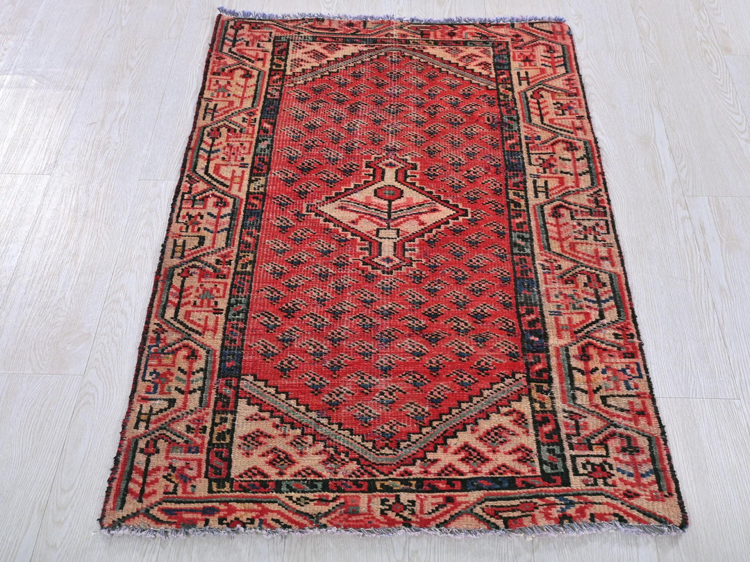 a red rug on a white wooden floor