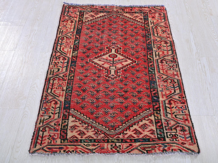 a red rug on a white wooden floor