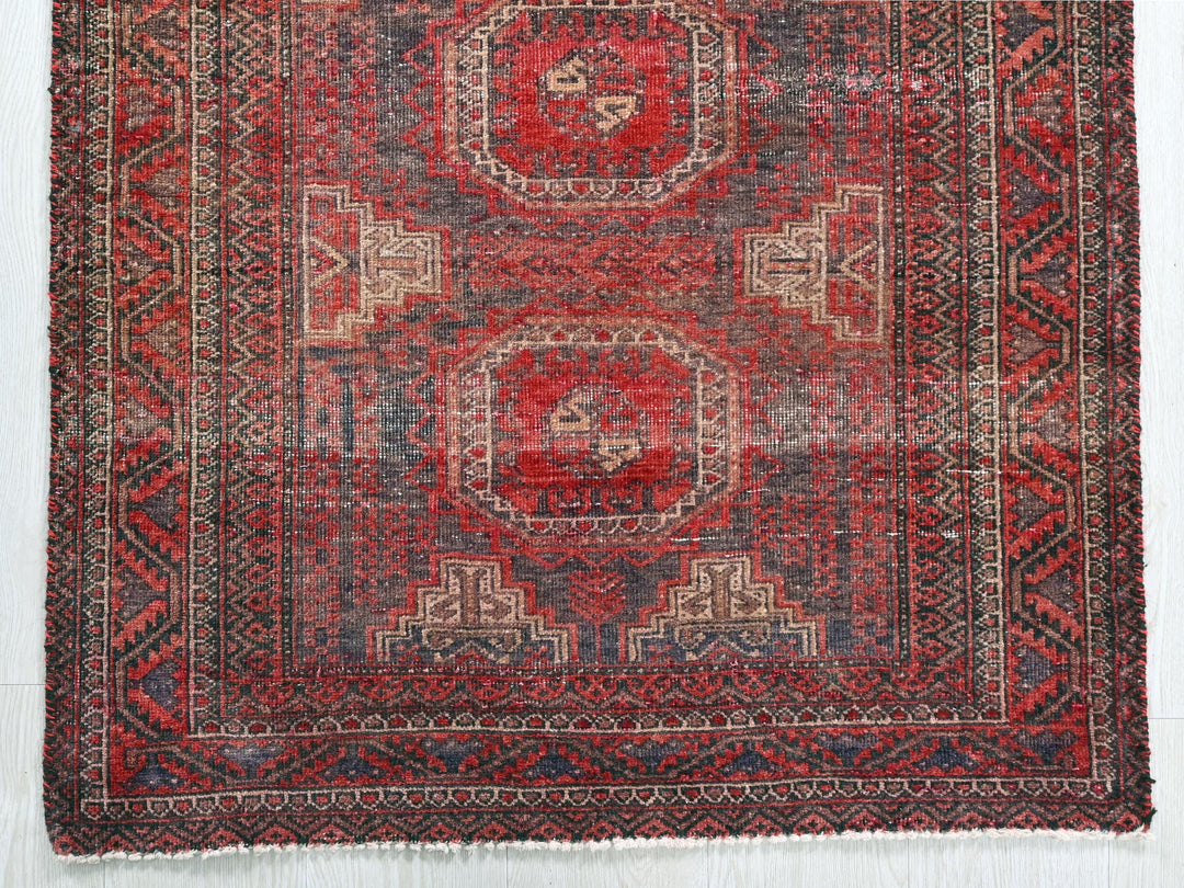 a red and blue rug with a design on it