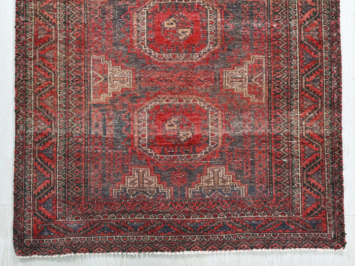 a red and blue rug with a design on it
