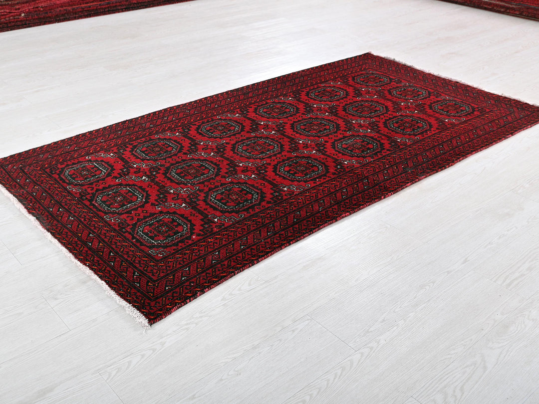 a red area rug on a white floor