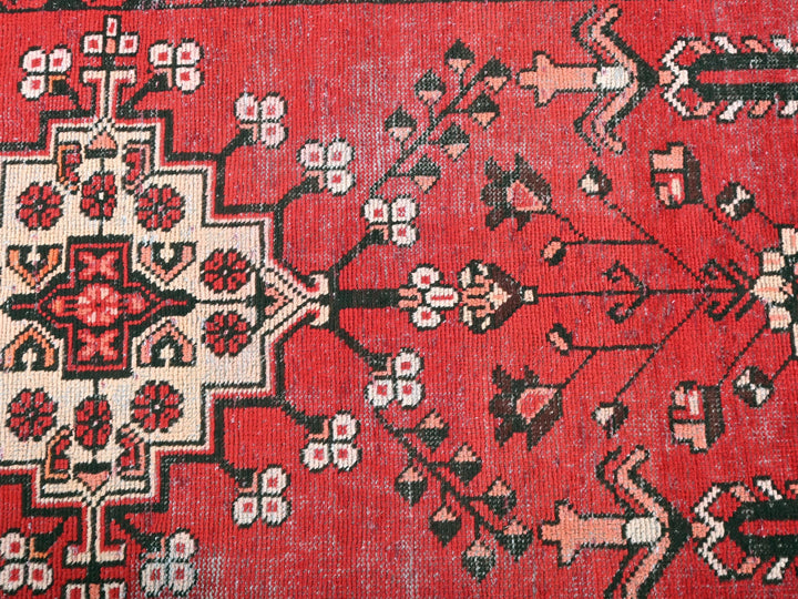 a red rug with black and white designs on it