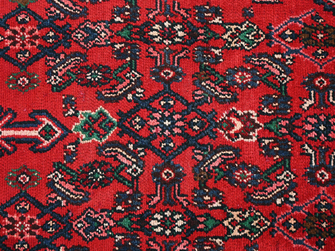 a close up of a red rug with a pattern on it