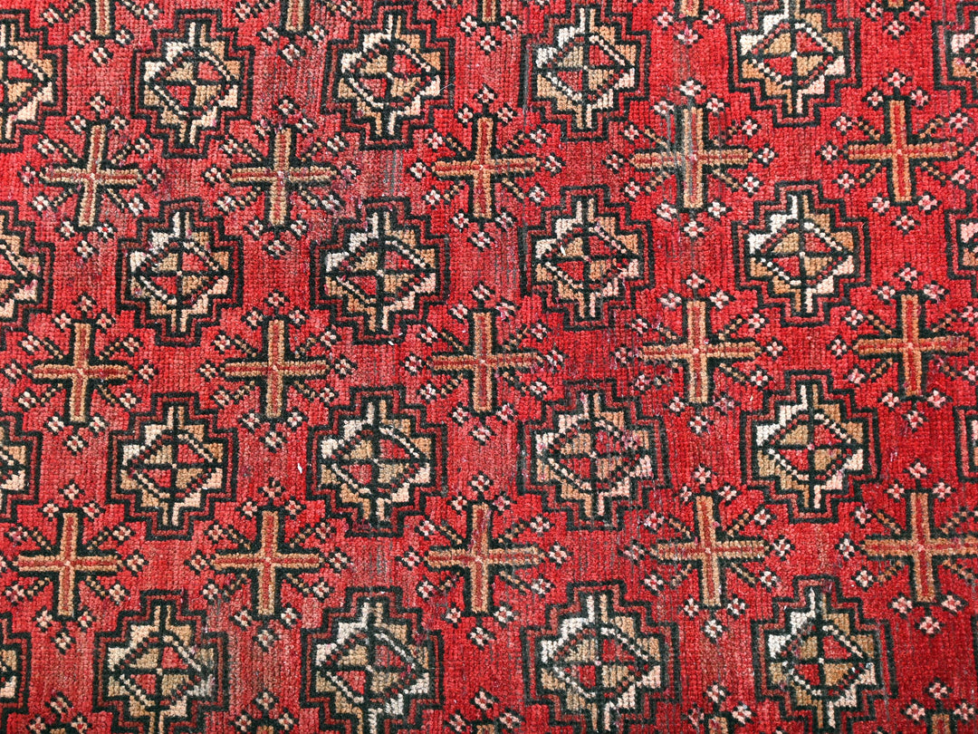 a close up of a red and black rug