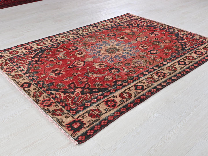 a red rug on the floor of a room