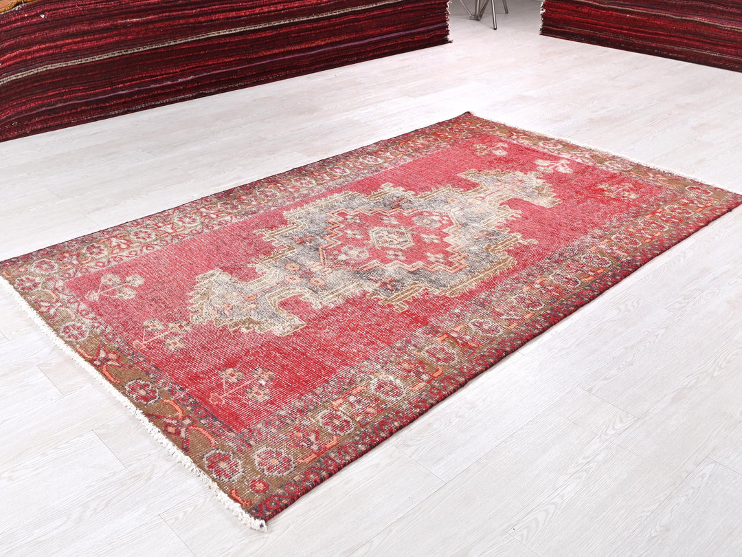 a red rug on the floor of a room