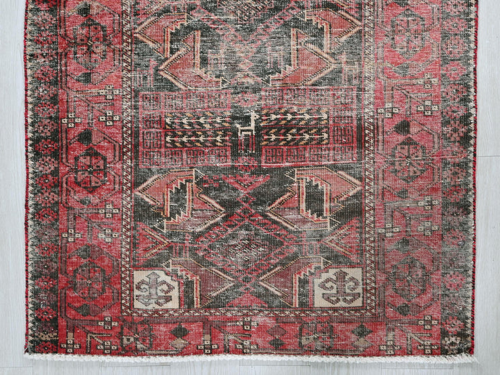 a red and black rug with a design on it