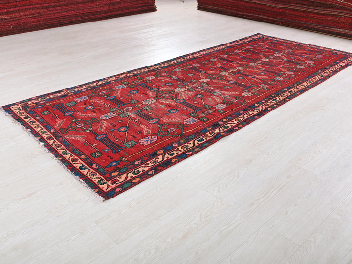 a red rug on the floor of a room