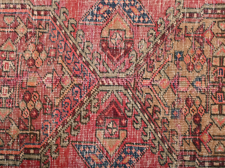 a red rug with a pattern on it
