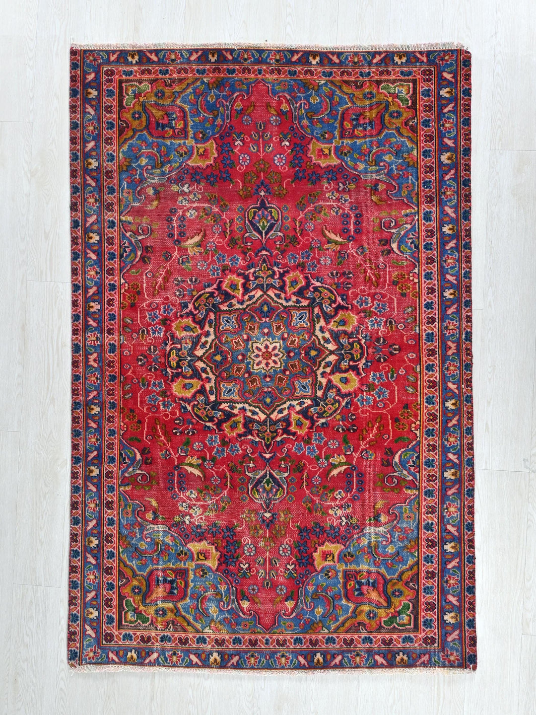 a red rug with a colorful design on it
