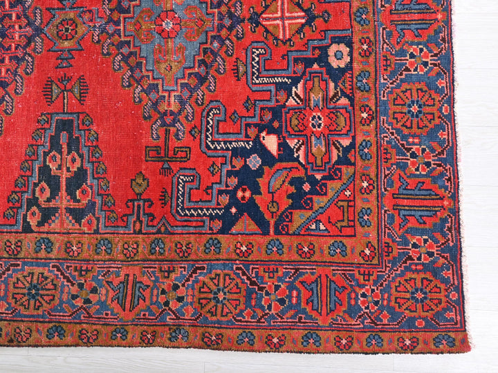 a red rug with blue and red designs on it