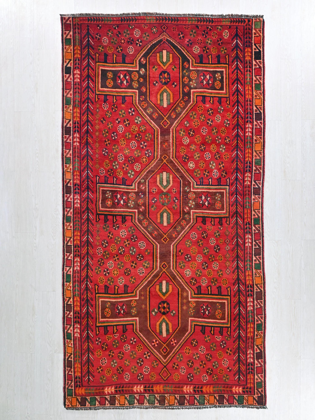 a red rug hanging on a wall