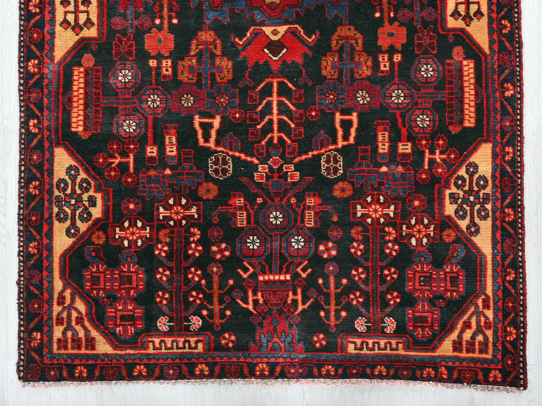 a red and black rug with a design on it