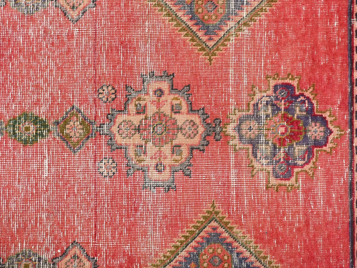 a red rug with a colorful design on it