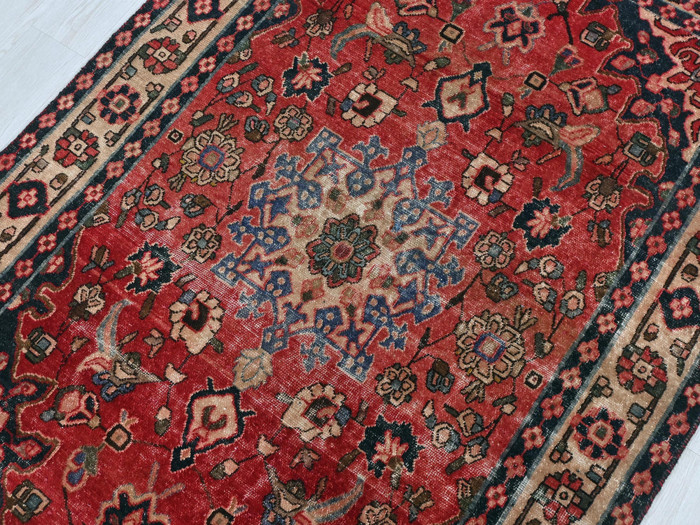 a red rug with a blue and red design on it