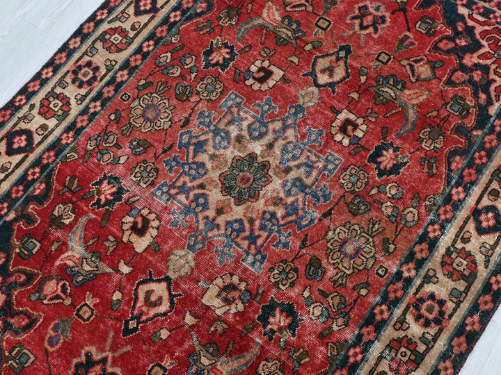 a red rug with a blue and red design on it