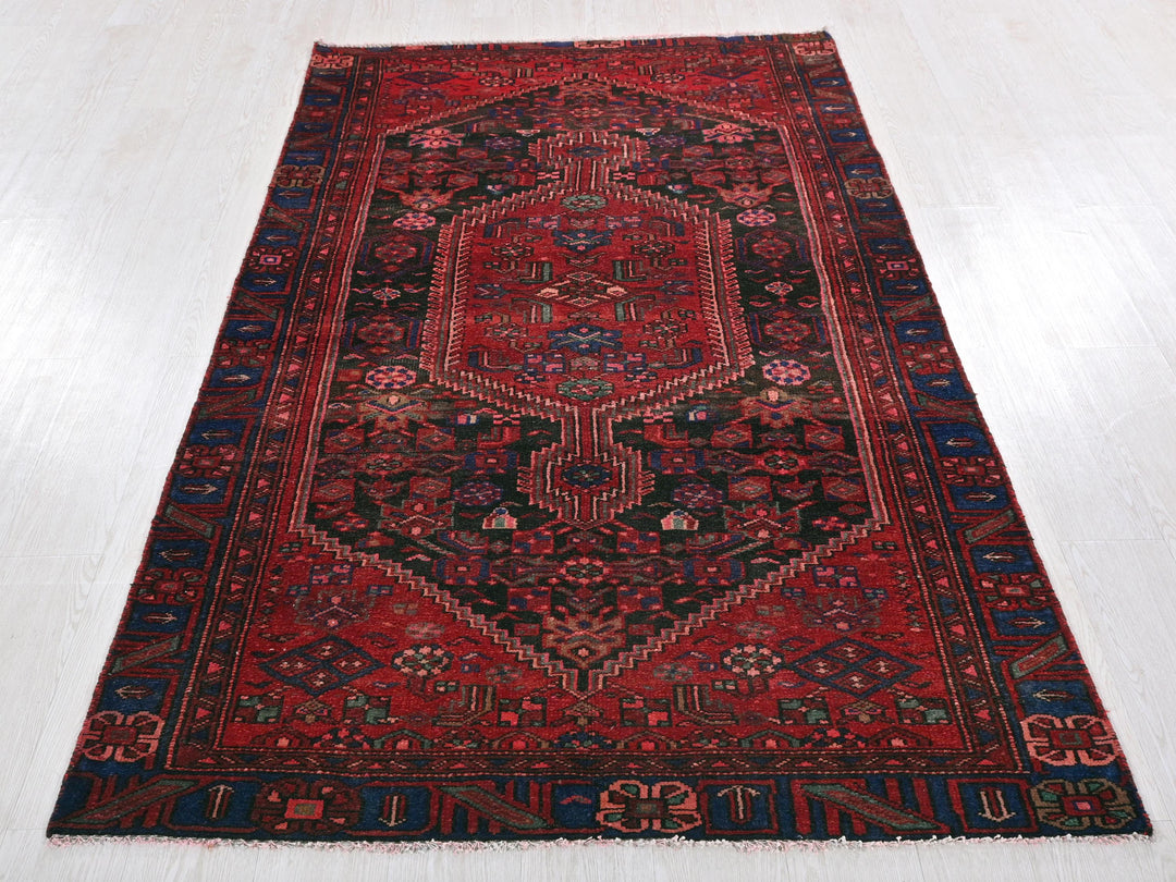 a red oriental rug on a white floor