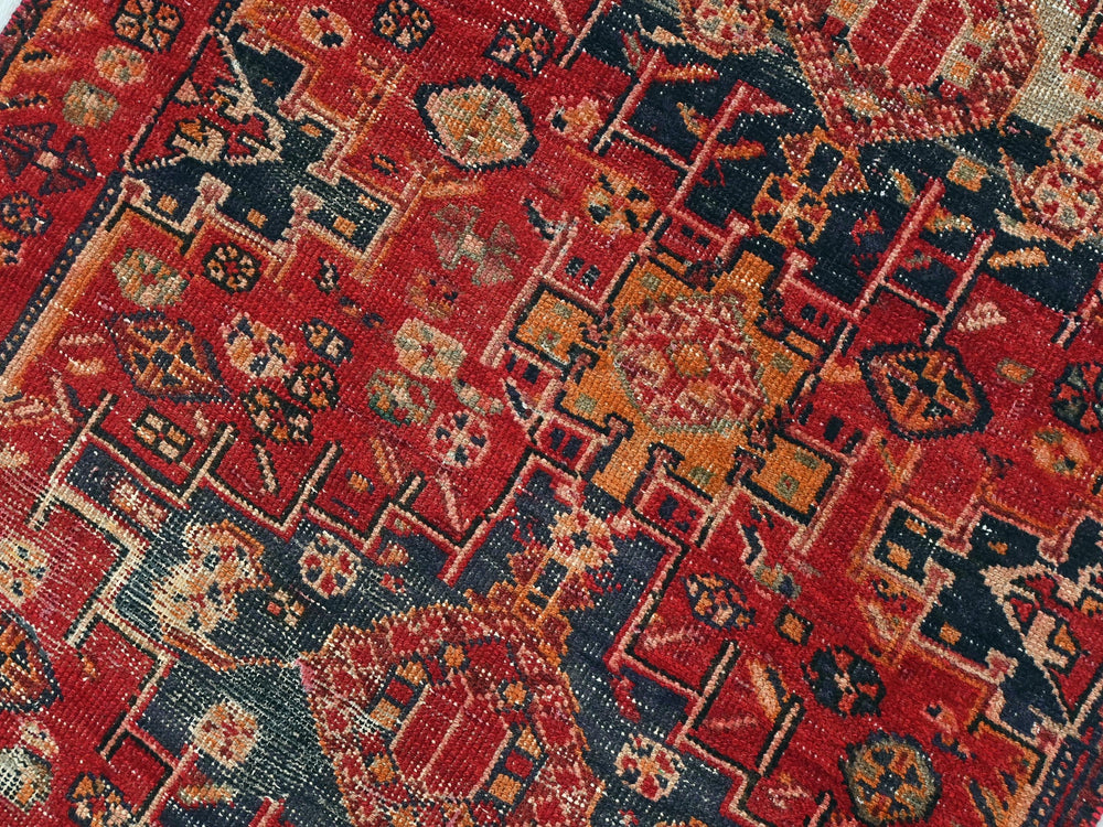 a red and blue rug with a pattern on it
