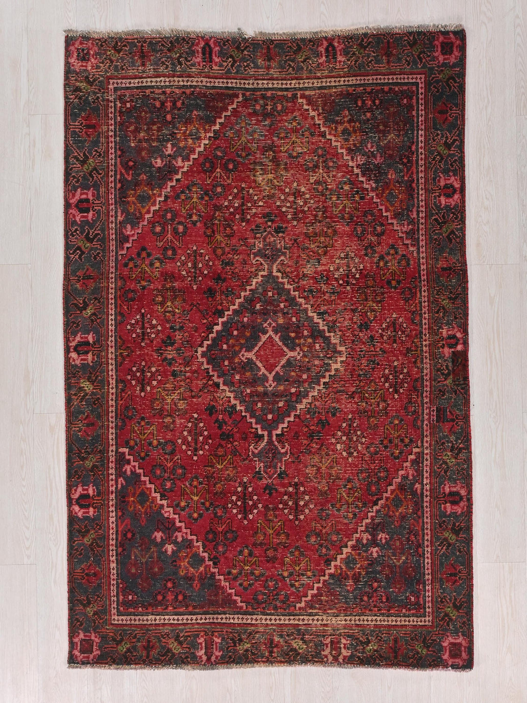 a red and black rug with a diamond design