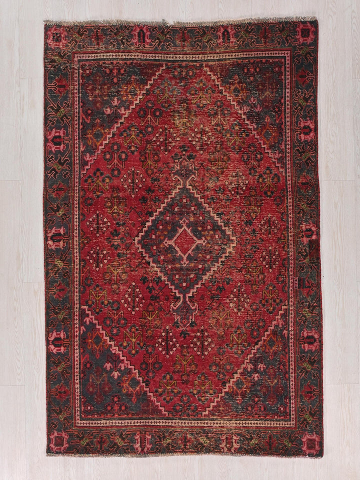 a red and black rug with a diamond design