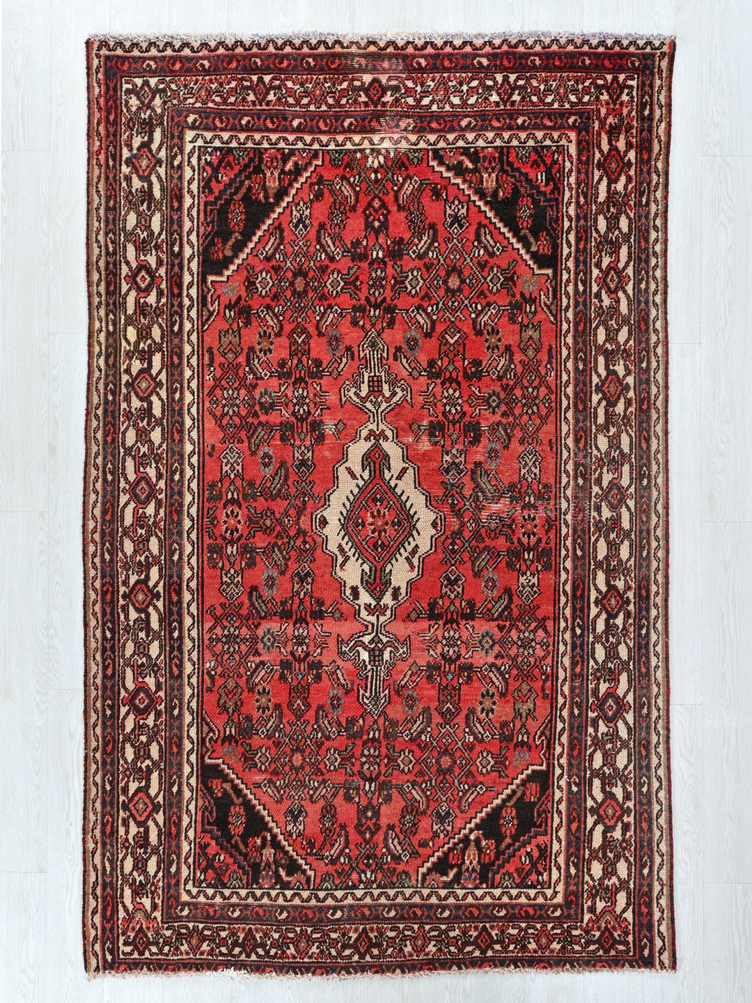 a red rug with an intricate design on it