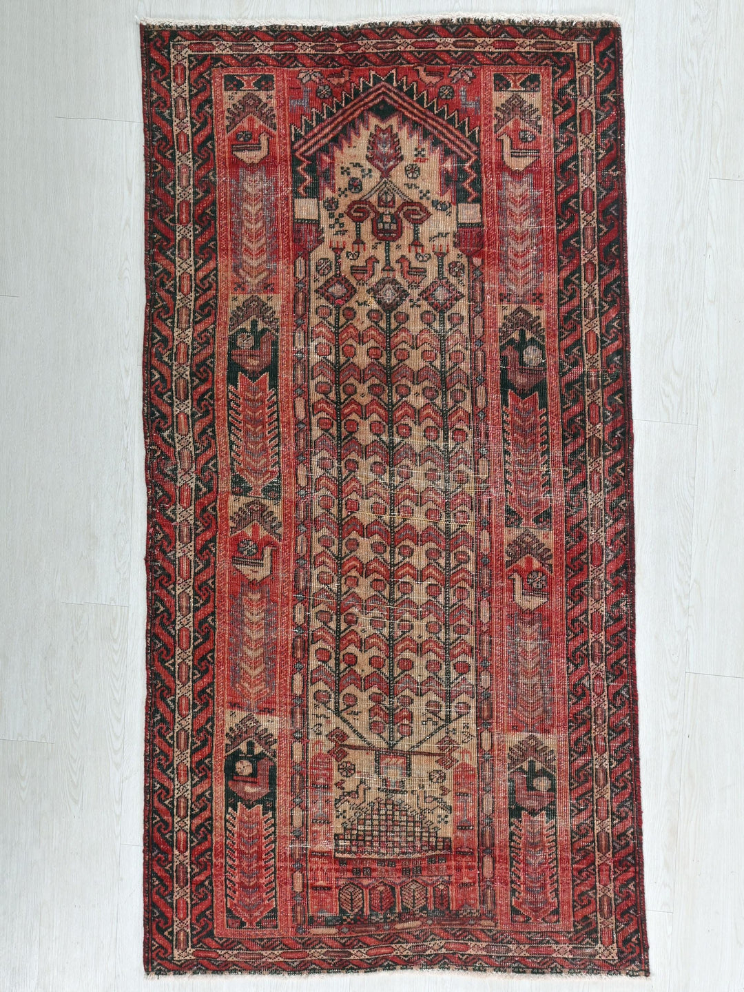 a red and black rug with elephants on it