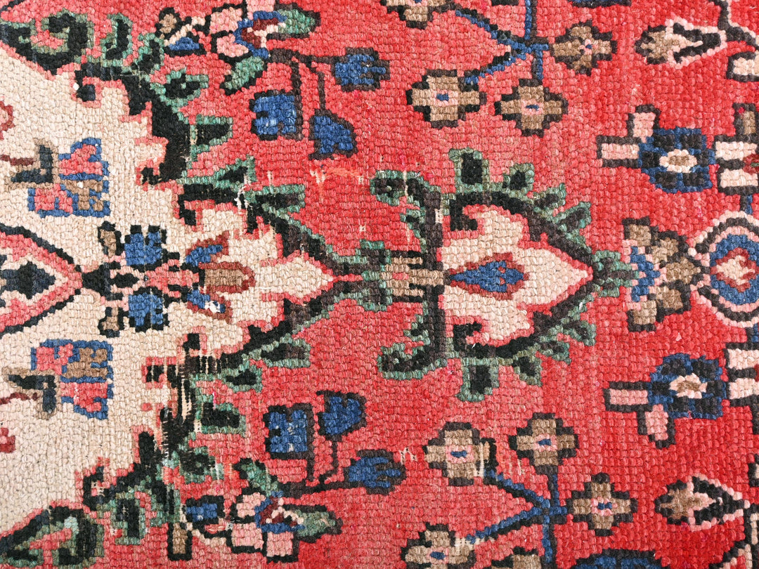 a close up of an oriental rug with a red background