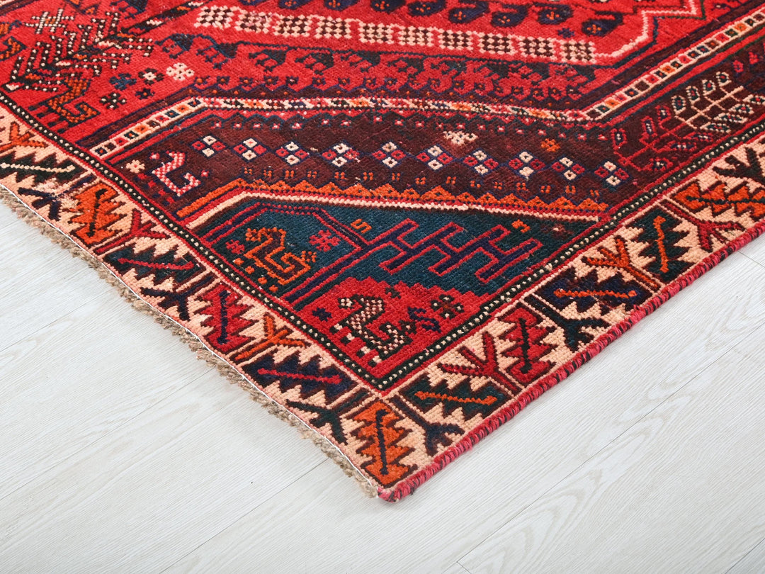 a red and blue rug on a white floor