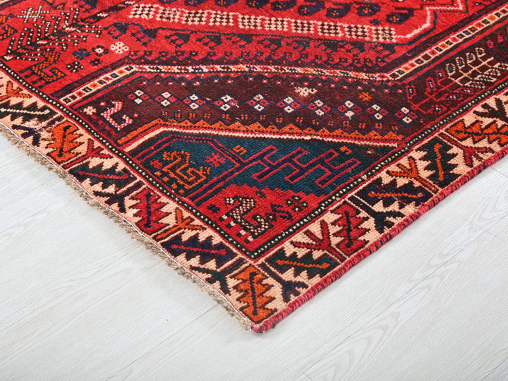 a red and blue rug on a white floor
