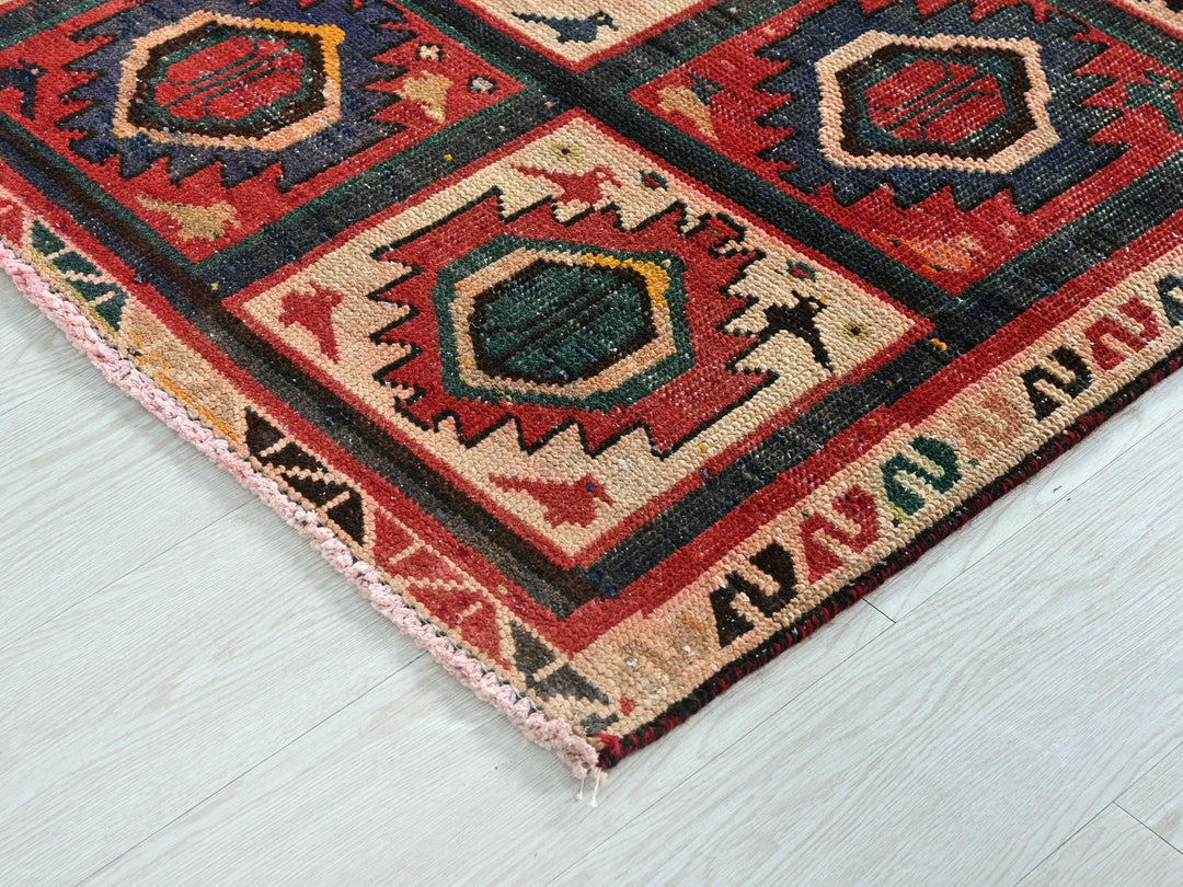 a red rug with a pattern on the middle of it