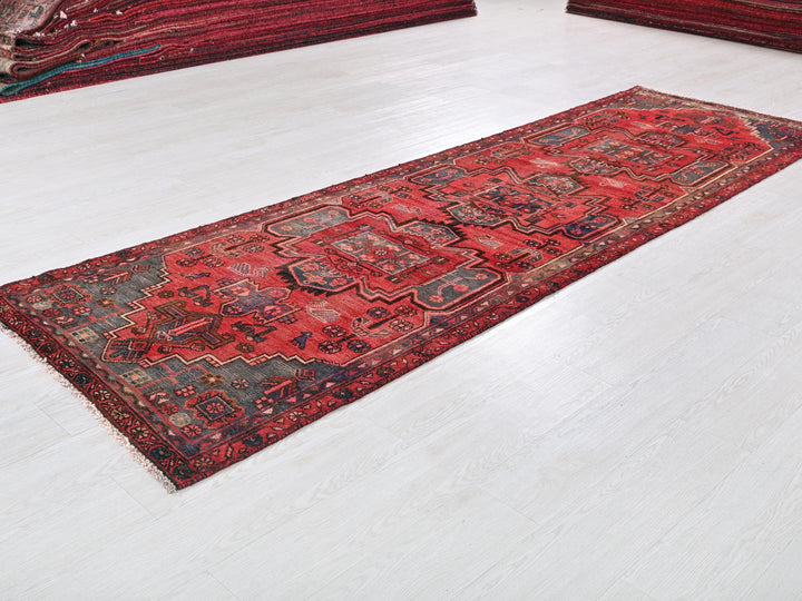 a red rug is laying on a white floor