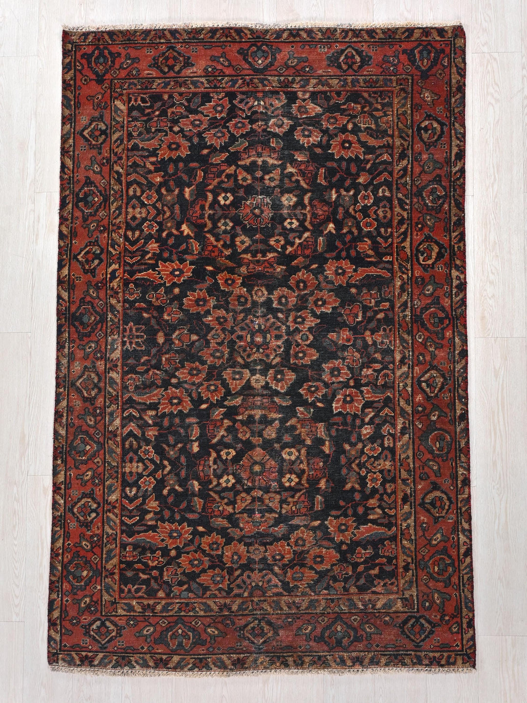 a rug with a red and black design on it