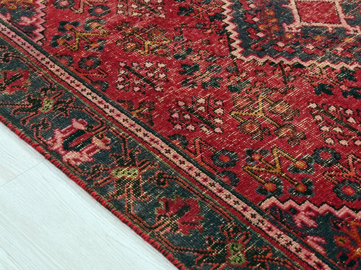 a red oriental rug on a white floor