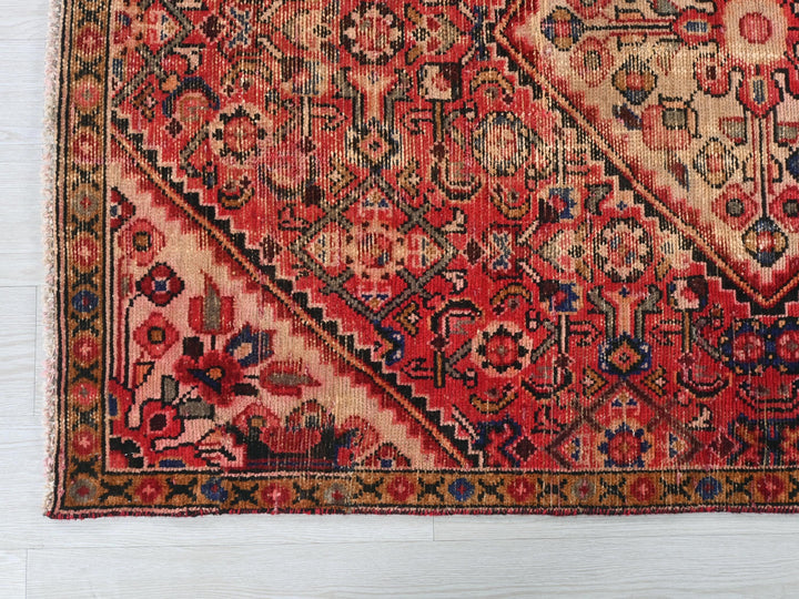 a red and blue rug on a white floor