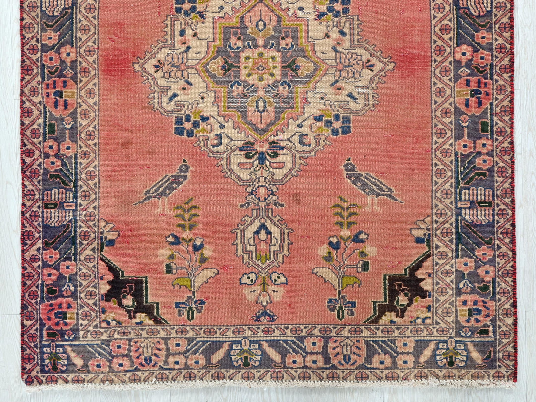 a red rug with an intricate design on it