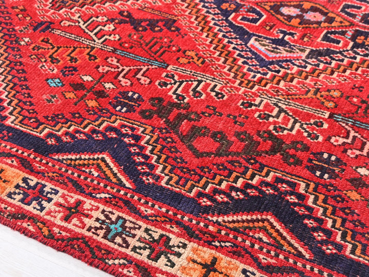 a red rug with a pattern on it