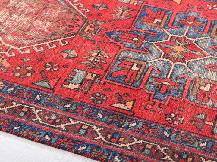a red rug with a blue and red design on it