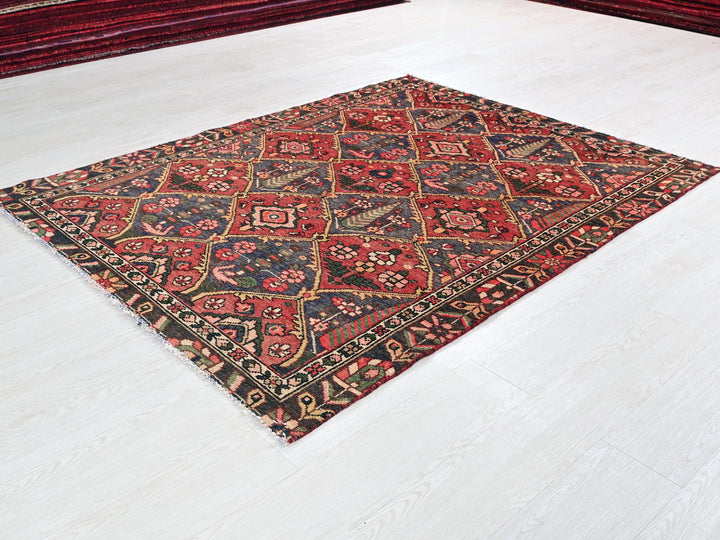 a red and black rug on a white floor