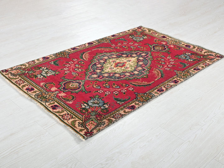 a red rug on a white wooden floor