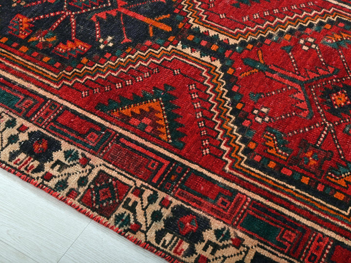 a close up of a red rug on the floor