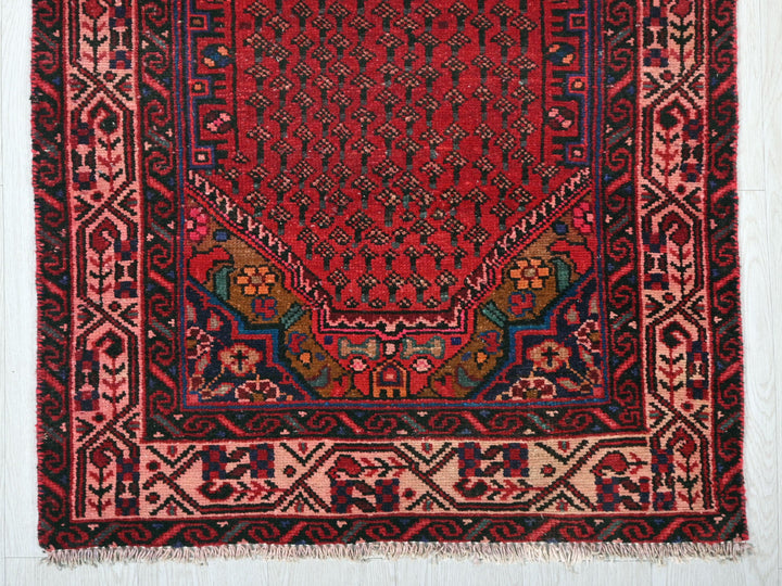 a red rug with a design on it