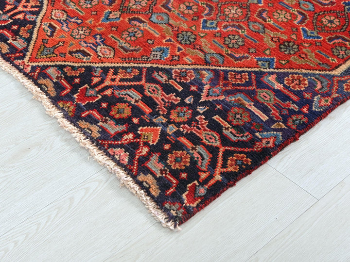 a red and blue rug on a white floor
