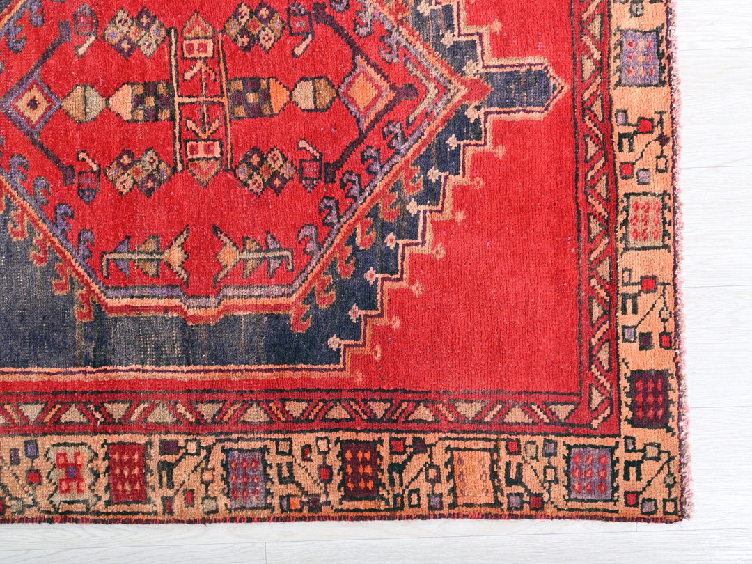 a red rug with a blue border on a white background